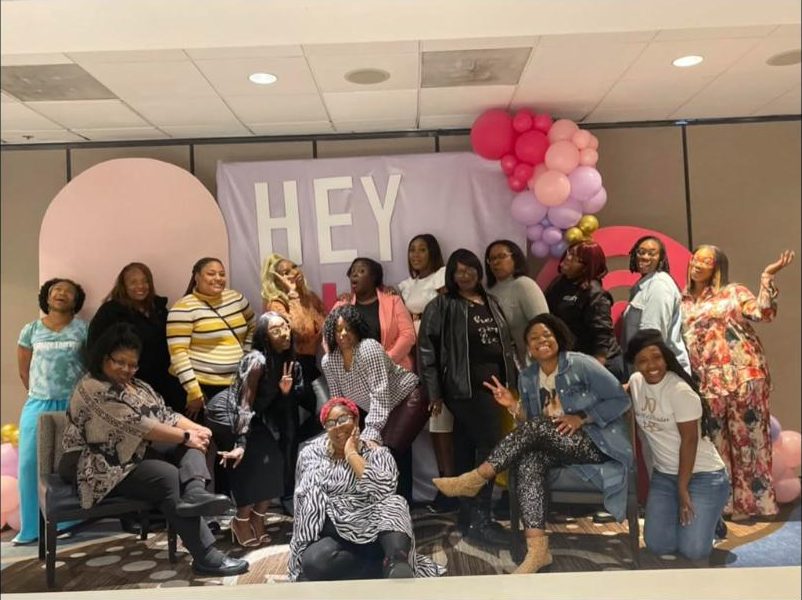 Hey Girl Hey attendees together at the backdrop